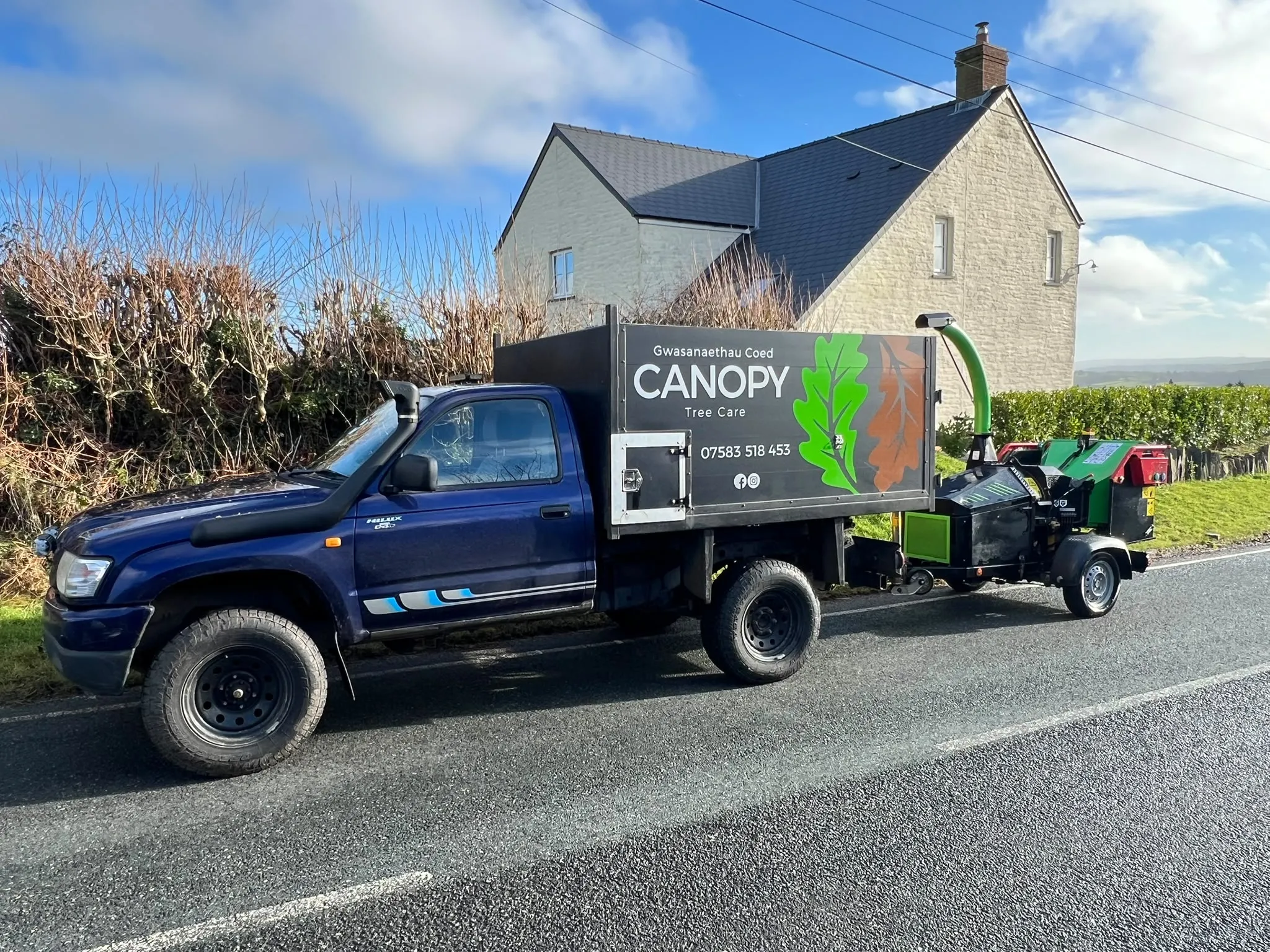 The Canopy Tree Care truck and wood chipper